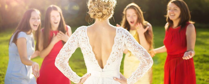 bride posing in front of her bridesmaid