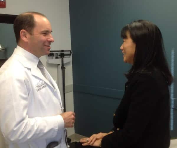 Dr. Deutsch speaking to a patient