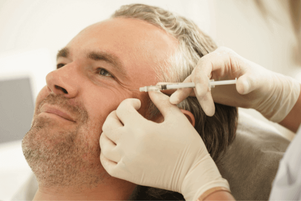 Middle aged male getting filler injection