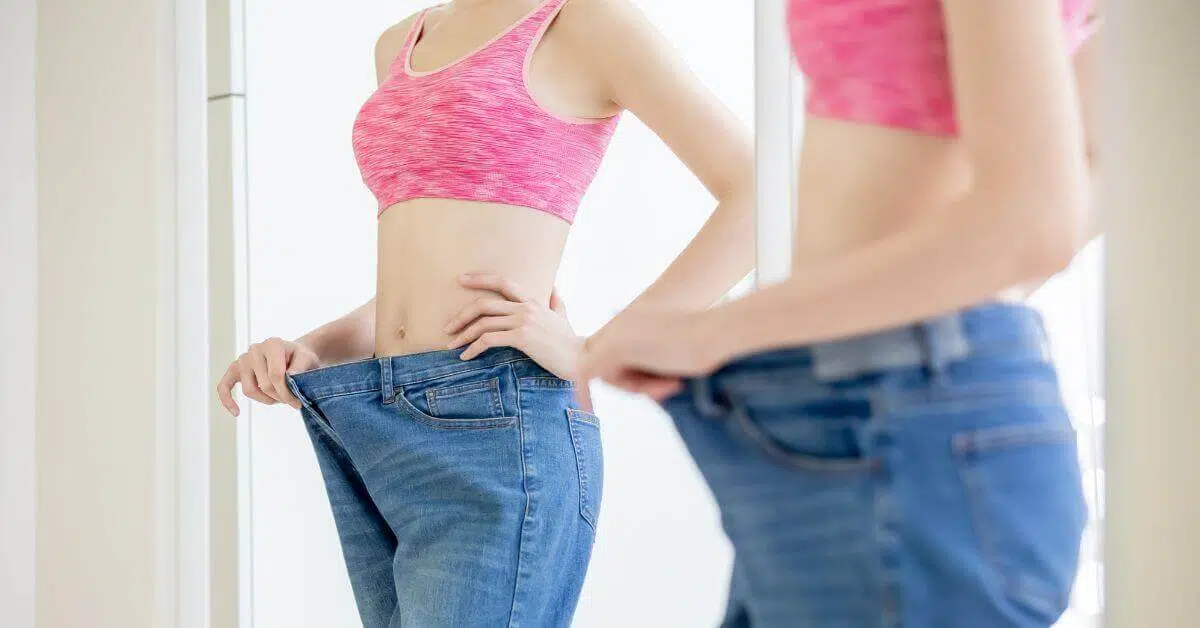 confident woman after doing a tummy tuck surgery
